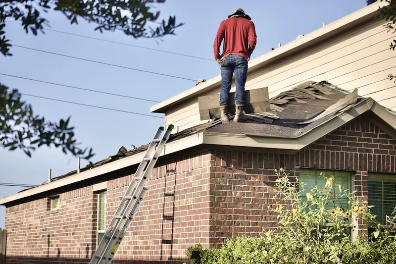 Professional roofer working on a residential roof in Smalltown